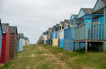 Colorful holiday beach huts. Vacations coastal wooden houses