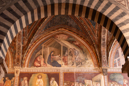 SAN GIMIGNANO, ITALY - SEPTEMBER 20, 2023 - Iconic renaissance architecture and frescoes in the San Gimignano cathedral