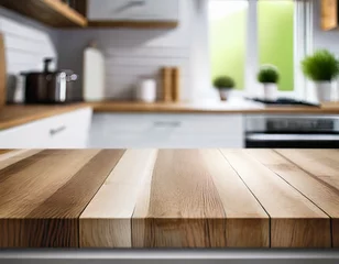 Fotobehang Selective focus on an empty wooden countertop with copy space for display products with a blurred white kitchen in the background. © Joe Hendrickson