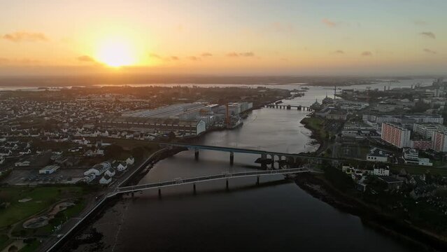 Industrial Lorient awakens to a vibrant sunrise.