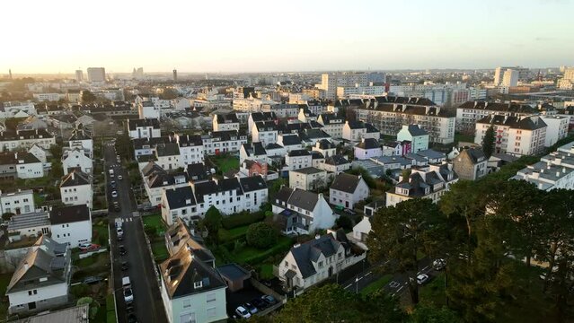 Sunrise bathes Lorient's residential area in light.