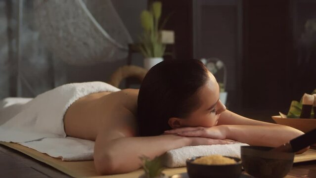 A Young, Healthy, and Beautiful Woman Receives Massage Therapy in a Spa Salon. Concept of Health and Well-being