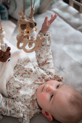 Cute baby playing with hanging toys
