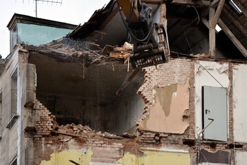 The construction site with the dismantling of the walls of the building on the street of the city....