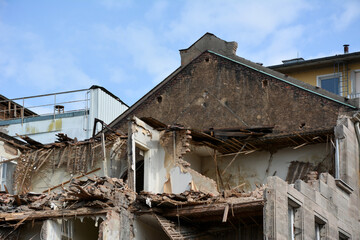 The construction site with the dismantling of the walls of the building on the street of the city. Reconstruction and renovation of cities