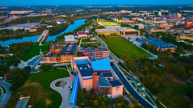Aerial Golden Hour over University Campus with River and Green Space