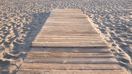 Obraz premium Sandy Beach Footpath with Wooden Planks