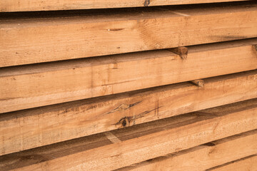 Stacked wooden pine beams closeup 