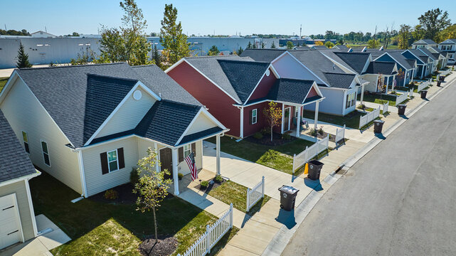 Aerial View of Colorful Suburban Homes with Neat Lawns and Porches