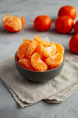 Organic Peeled Mandarin Oranges in a Bowl, side view.