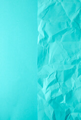 Crumpled blue paper and smooth paper background