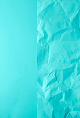 Obraz premium Crumpled blue paper and smooth paper background