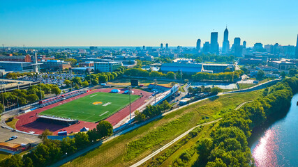 Aerial View of Urban Stadium and City Skyline with River