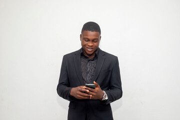 Portrait of successful Handsome businessman on suit using phone standing on a white background