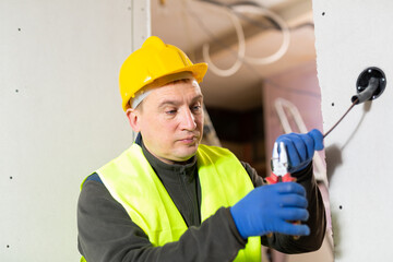 Electrician installing electricity in a new house