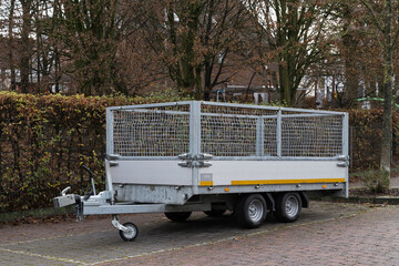 Side view of a car trailer standing in a parking lot.