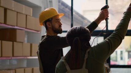 African american warehouse manager and assistant perform inventory inspection, keeping quality...