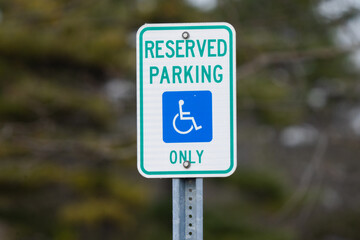 mounted sign sign says reserved parking for handicap only