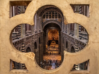 Naklejka premium SIENA, ITALY - SEPTEMBER 23, 2023 - View to the nave of the cathedral in Siena, seen from the upper floor