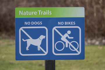 public sign says no bikes or dogs allowed on nature trails