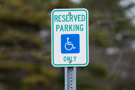 mounted sign sign says reserved parking for handicap only