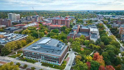 Aerial View of University Campus with Autumn Foliage and American Flag