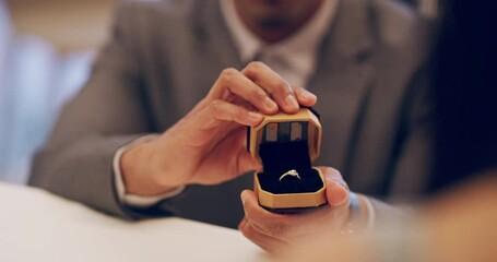 Engagement, surprise and ring with hands of couple in restaurant for love, proposal and romance celebration. Marriage, support and diamond with man and woman for date, dinner and valentines day