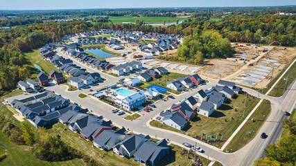 Aerial Suburban Expansion with Community Pool and Construction Zone