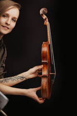 Classical violin, modern tattoo, musician's dual expression