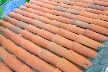 Antique clay roof made of semicircular tiles. Background with selective focus and copy space