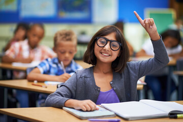 Girl, portrait and raise hand in class, elementary school and answer teacher question. Students, study and childhood development for education, knowledge and academic information for people