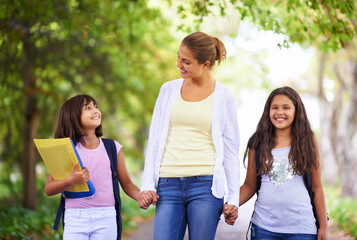Happy teacher, students and holding hands walking to school in outdoor park for support or...