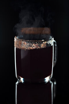 Mulled Wine steaming with cinnamon stick and sugar rim on a clear mug