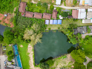 Top down aerial view of a small lake and tropical foliage in Bang Niang, Thailand