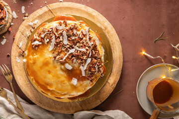 Delicious salted caramel cake with pecan nuts and coconut flakes