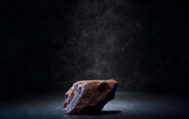 stones and ice for the podium. natural brown stones in a thin layer of ice on a dark background for...