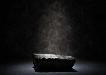 stones and ice for the podium. natural black stones in a thin layer of ice on a dark background for the presentation of a product cosmetics medicine perfumery jewelry