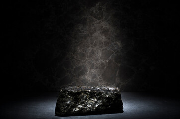 stones and ice for the podium. natural black stones in a thin layer of ice on a dark background for the presentation of a product cosmetics medicine perfumery jewelry - obrazy, fototapety, plakaty