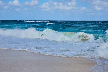 Crashing Waves and Sandy Beach Under Cumulus Clouds, Bahamas