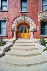 Fototapeta na wymiar Classic Brick Entrance with Ornate Archway,Wooden Doors, Downtown Indianapolis