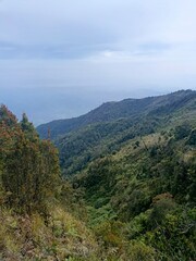 View of the mountains from above with beautiful sunlight and gathering clouds. View of the hills taken from a height with beautiful sunlight and clouds. 