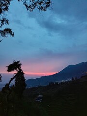 Purple sunset view taken from the top of the mountain. Mountain views with sunset atmosphere. 