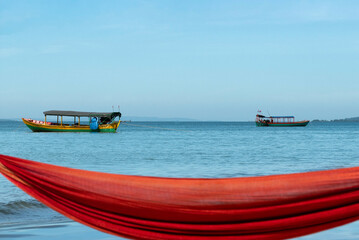 Boats on the sea with blurred hammock in the foreground