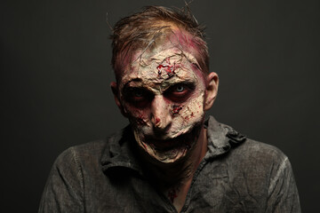 Scary zombie on dark background. Halloween monster