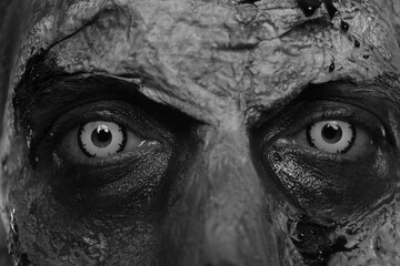 Closeup view of scary zombie, black and white effect. Halloween monster