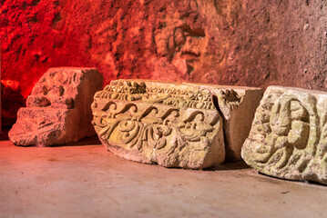 Beautifully carved stone architectural pieces inside the museum cave at Bet She`arim National Park in Kiryat Tivon, Israel.
 - Powered by Adobe