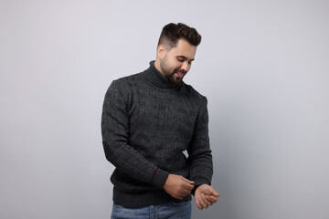 Happy man in stylish sweater on white background