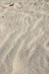 Fototapeta na wymiar Textured Sand Patterns and Ridges Close-Up Beach Detail