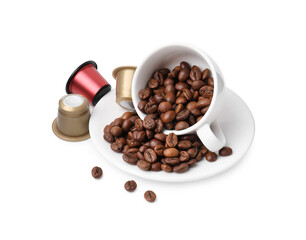 Coffee capsules, beans, cup and saucer isolated on white