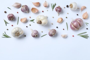 Fresh garlic, rosemary and peppercorns on white background, flat lay. Space for text